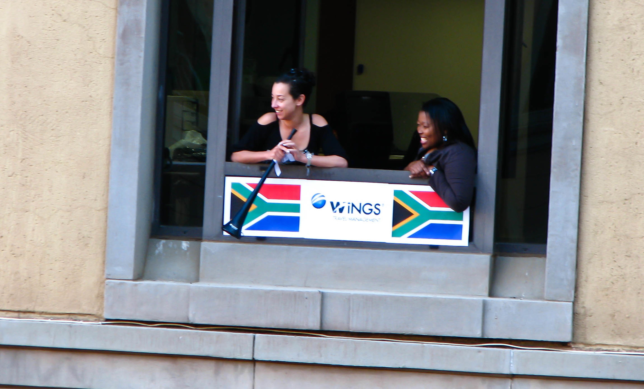 Black and white ladies celebrating the springboks